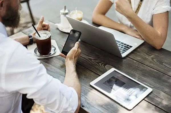 employees working on multiple electronic devices