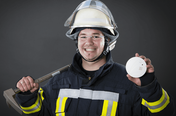 Firefighter with smoke alarm.