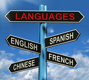 multi-directional sign with languages English Spanish Chinese and French