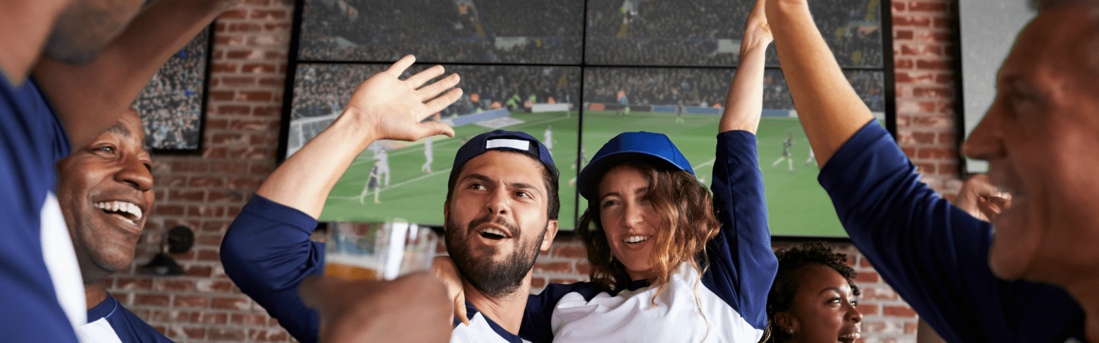 Couple cheering during tv game