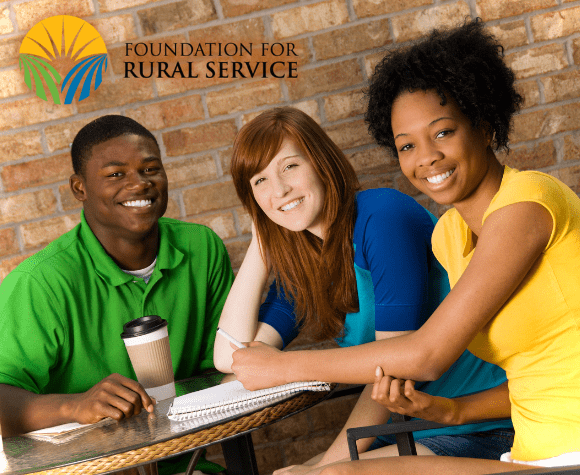 Group smiling with 'Foundation for Rural Service' logo at the top on the image