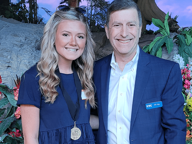 CEO Mike Hagg and a 2022 REEL Kids recipient receiving her medal at the Ripley's Aquarium in Myrtle Beach. April 2022.