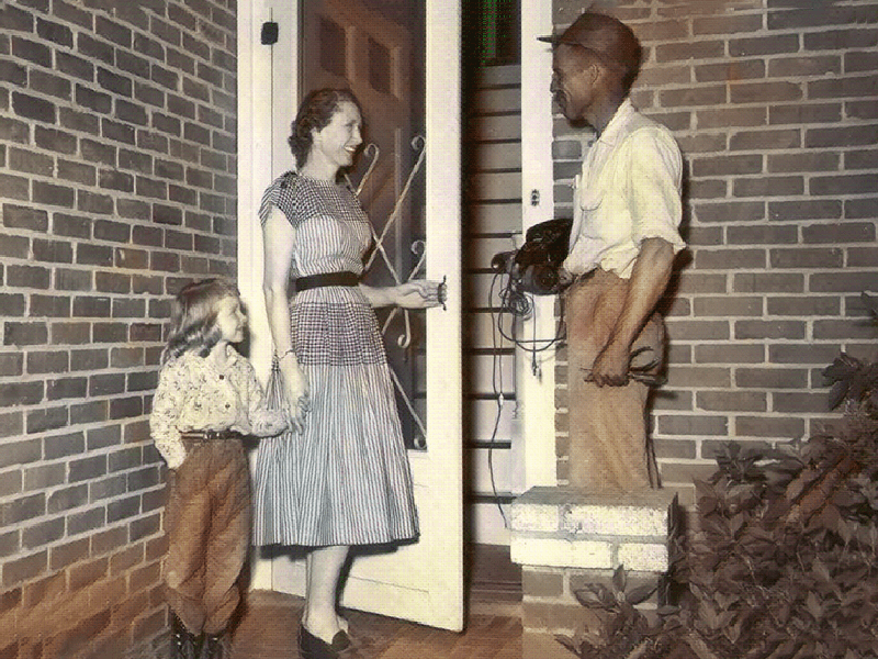 Old photo of HTC technician servicing family.
