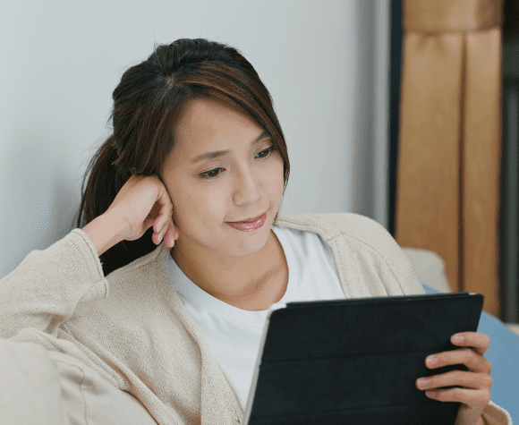 Woman watching tv on her tablet