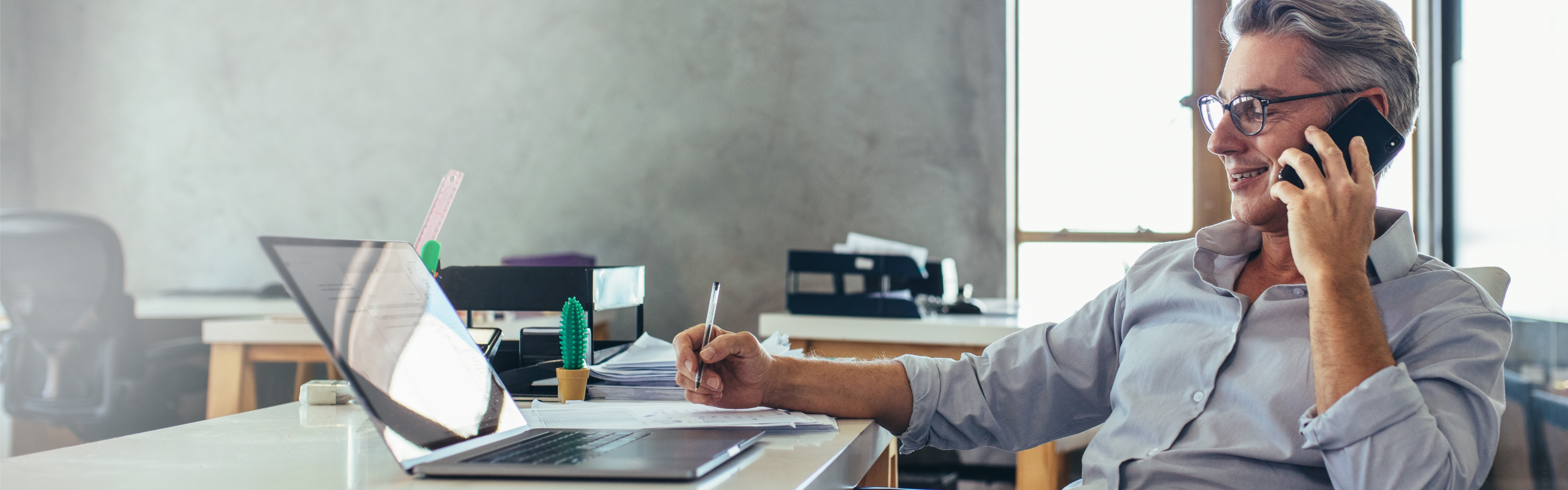 business owner working on laptop and talking on the phone.