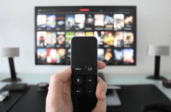 Image of remote with tv in background.