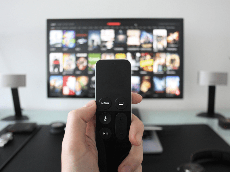 Image of remote with tv in background.