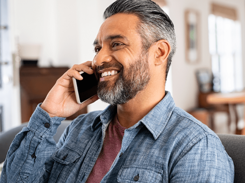 Man smiling on phone.