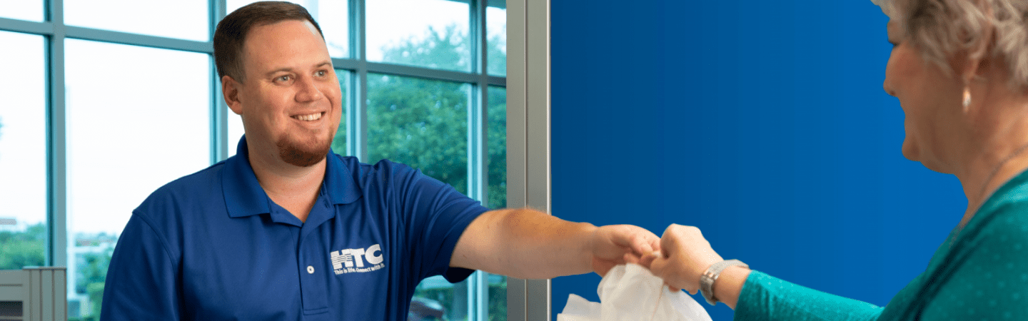 HTC employee helping customer.