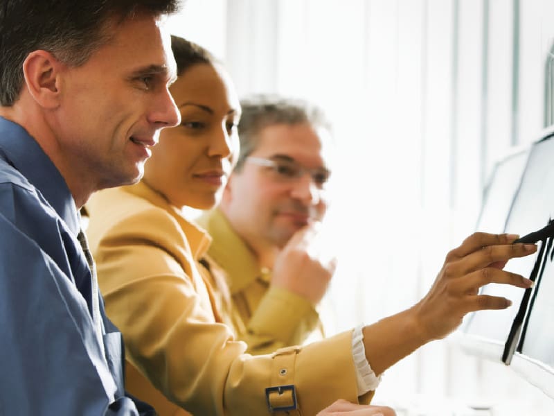 Group going over work on computer.