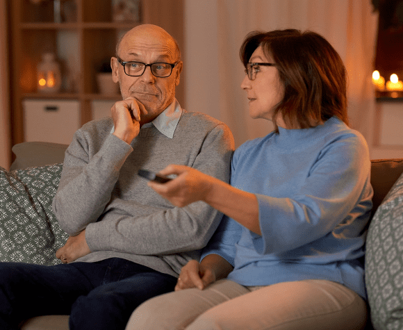 couple discussing video streaming while changing the channel