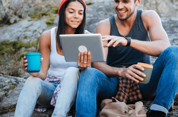 Outdoorsy couple using tablet