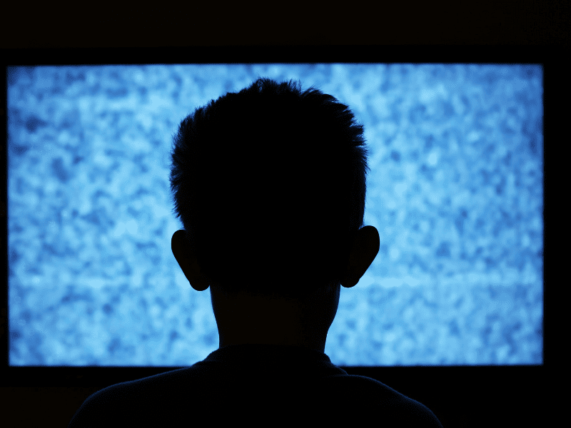 boy looking at blank tv screen