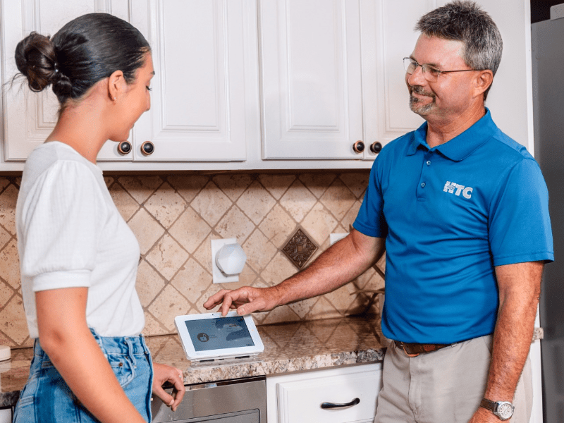 HTC tech setting up woman's new home security system