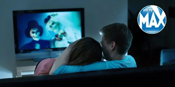 Couple watching a scary movie from their couch
