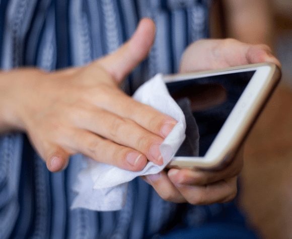 Person cleaning their cellphone