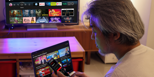 Man streaming on his phone, tablet, and TV