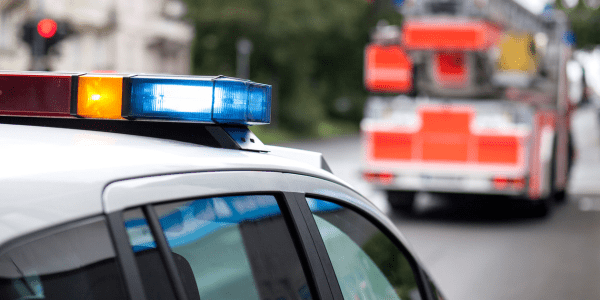 Police car following a fire truck