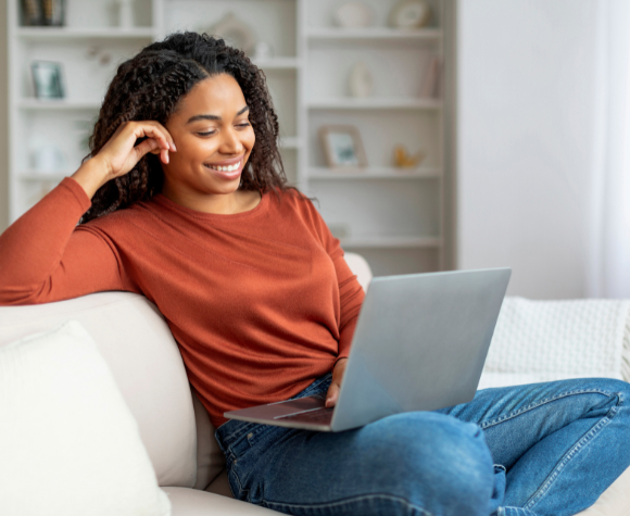 Woman smiles while on laptop