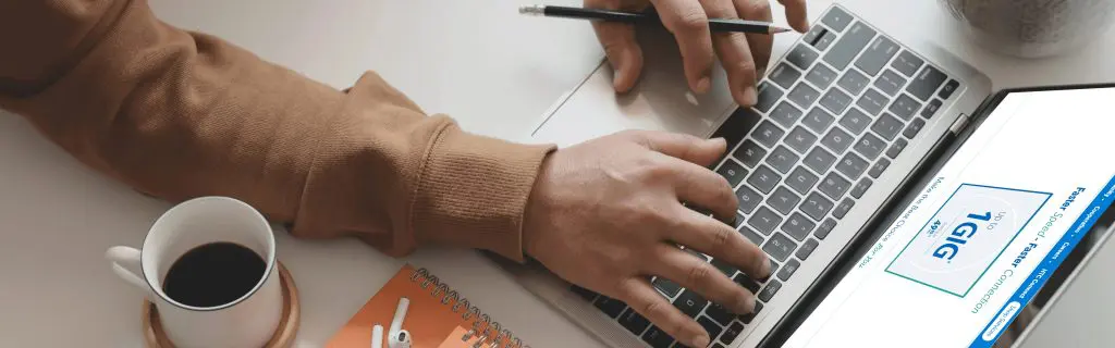 Close-up of hands on a laptop keyboard with a screen displaying the HTC promise: "Faster speed - Faster Connection."