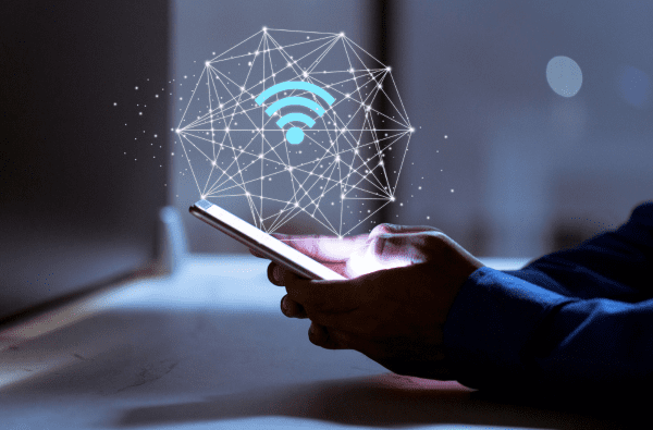 man holding phone with symbols indicating wi-fi strength and optimization