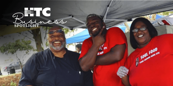 Michael Chestnute of Big Mike's Soul Food at a pop-up food stall with two employees.