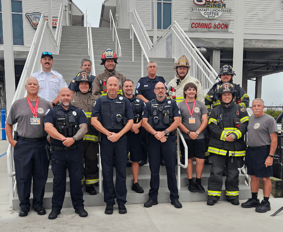 Group of Surfside firefighters at foot of stairs honoring 9/11 with memorial stair climb.