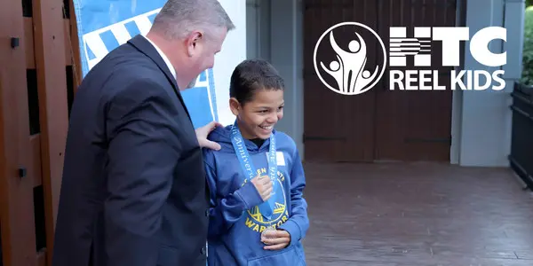 REEL Kid receiving medal at 2025 ceremony