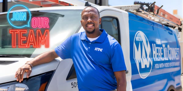 HTC Employee next to a company vehicle