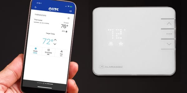 thermostat on the wall and cellphone with app