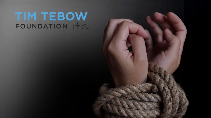 a doctor and young patient goofing around with red noses.