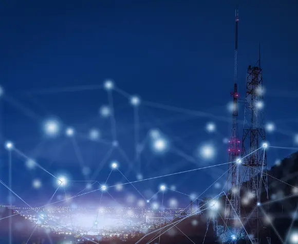 light in sky indicating wireless connection in a town