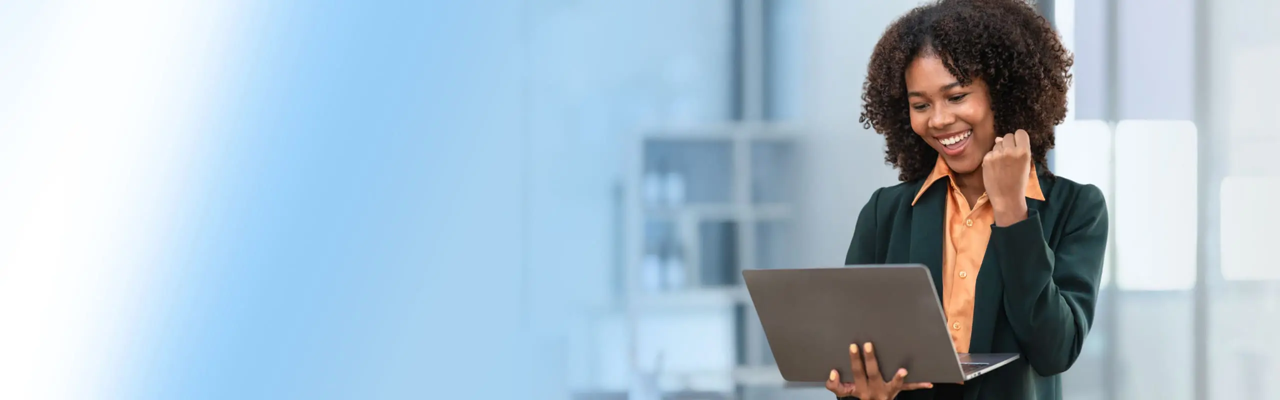 business woman on laptop celebrating success
