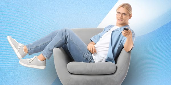 man on chair with remote pointing at screen