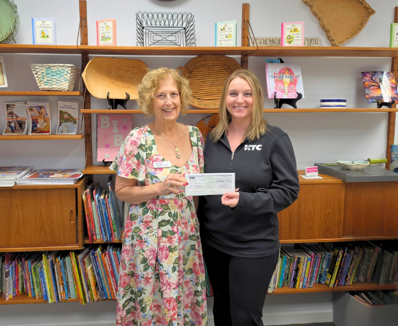 HTC presenting a check to literacy organization