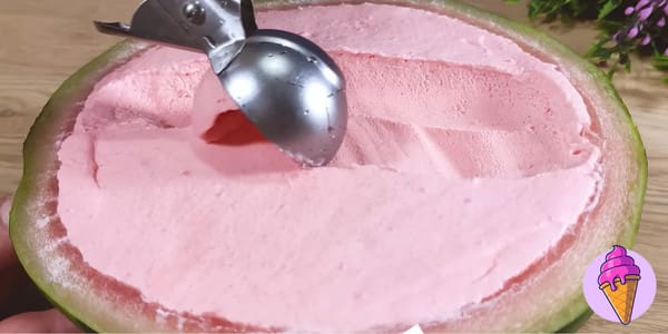 watermelon ice cream being scooped out of the rind