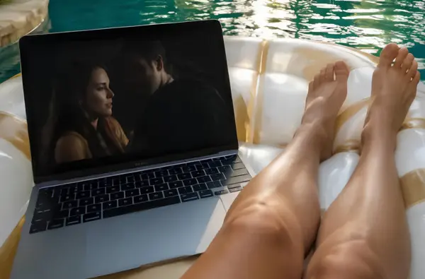 woman watching tv on a pool float