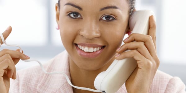 woman on landline phone and twirling cord