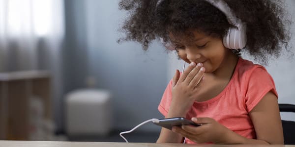 young girl enjoying content on a smart phone
