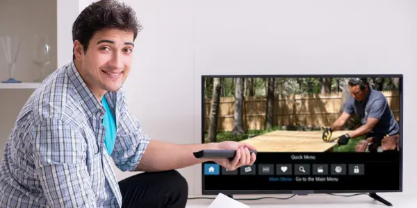 smiling man in front of TV