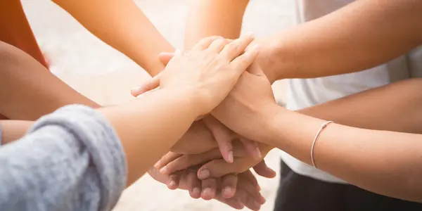 group of hands in a circle