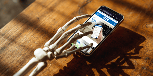 skeleton hand scrolling on cellphone